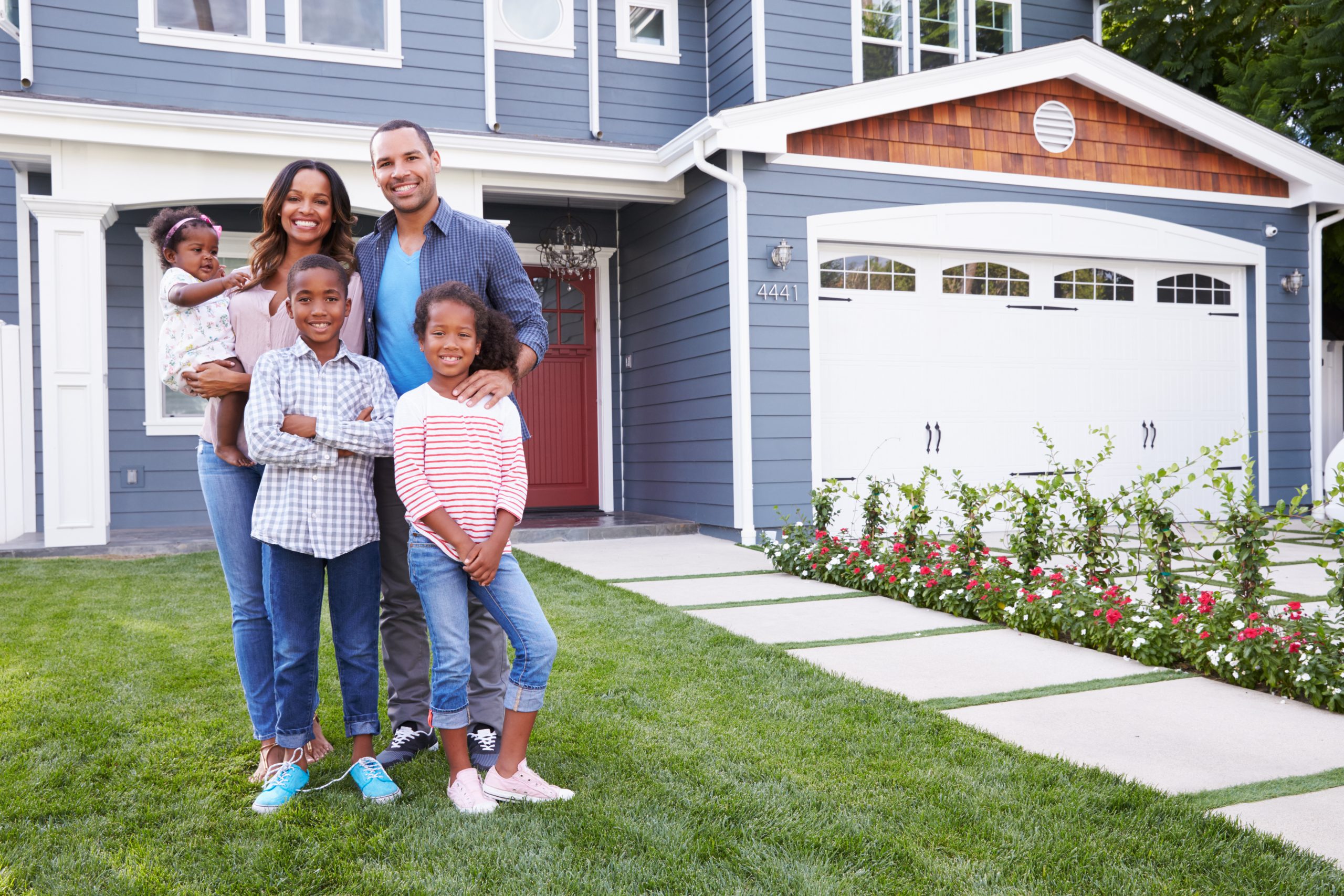 Happy,Black,Family,Standing,Outside,Their,House